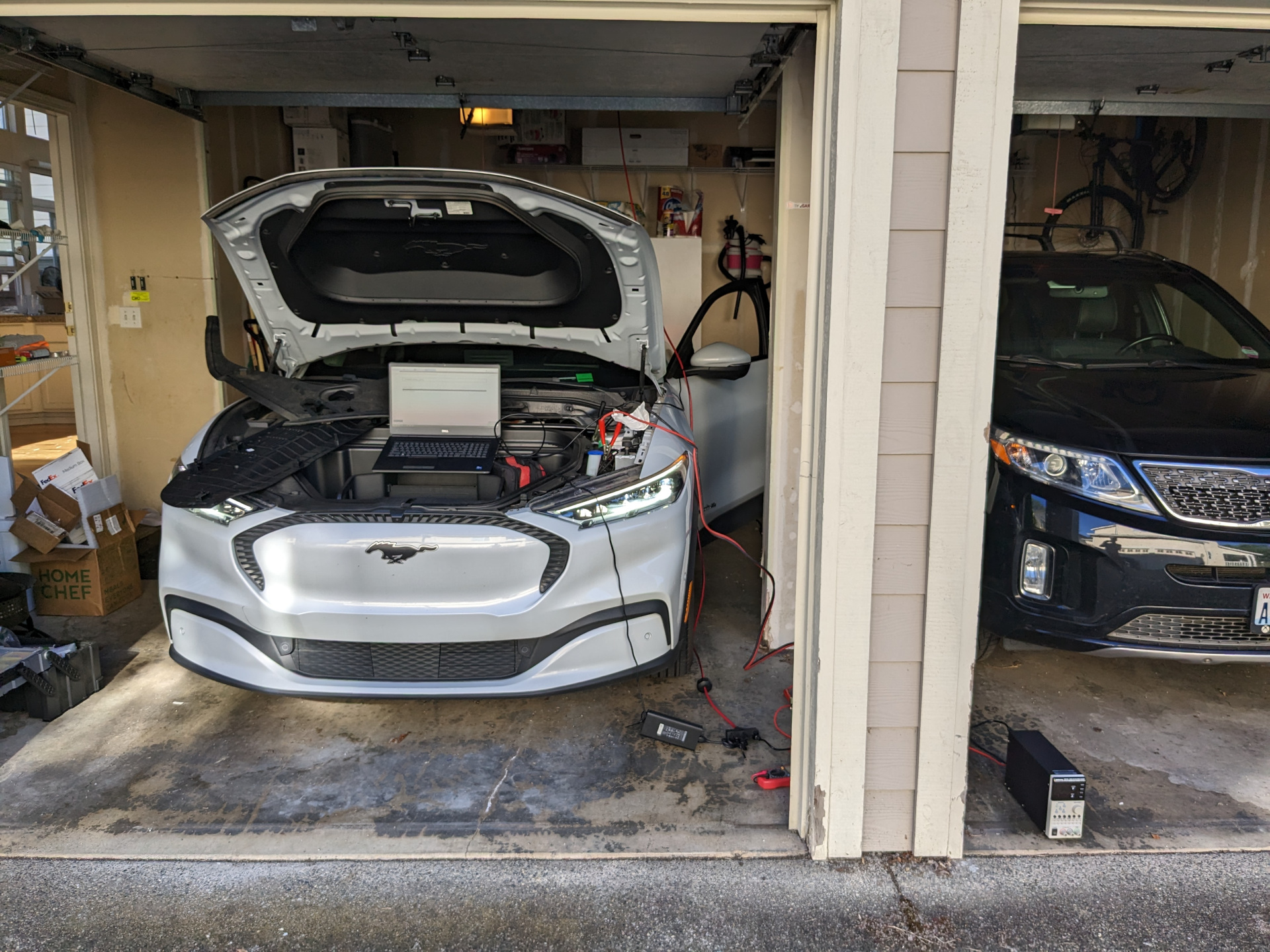 A Mach-E in my garage with the frunk disassembled