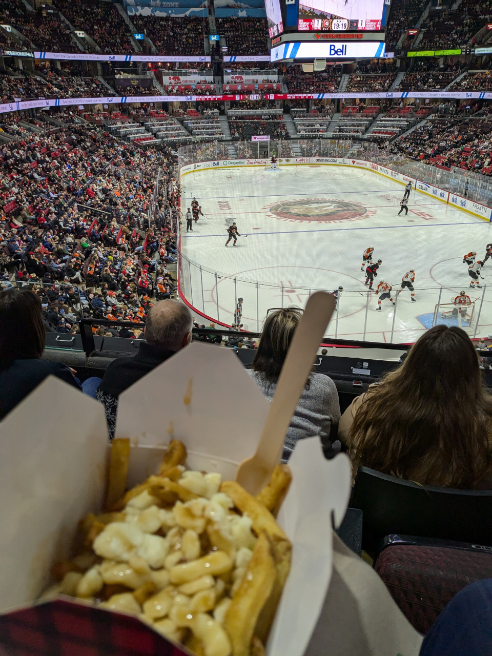 An Ottawa Senators hockey game with poutine in my hand